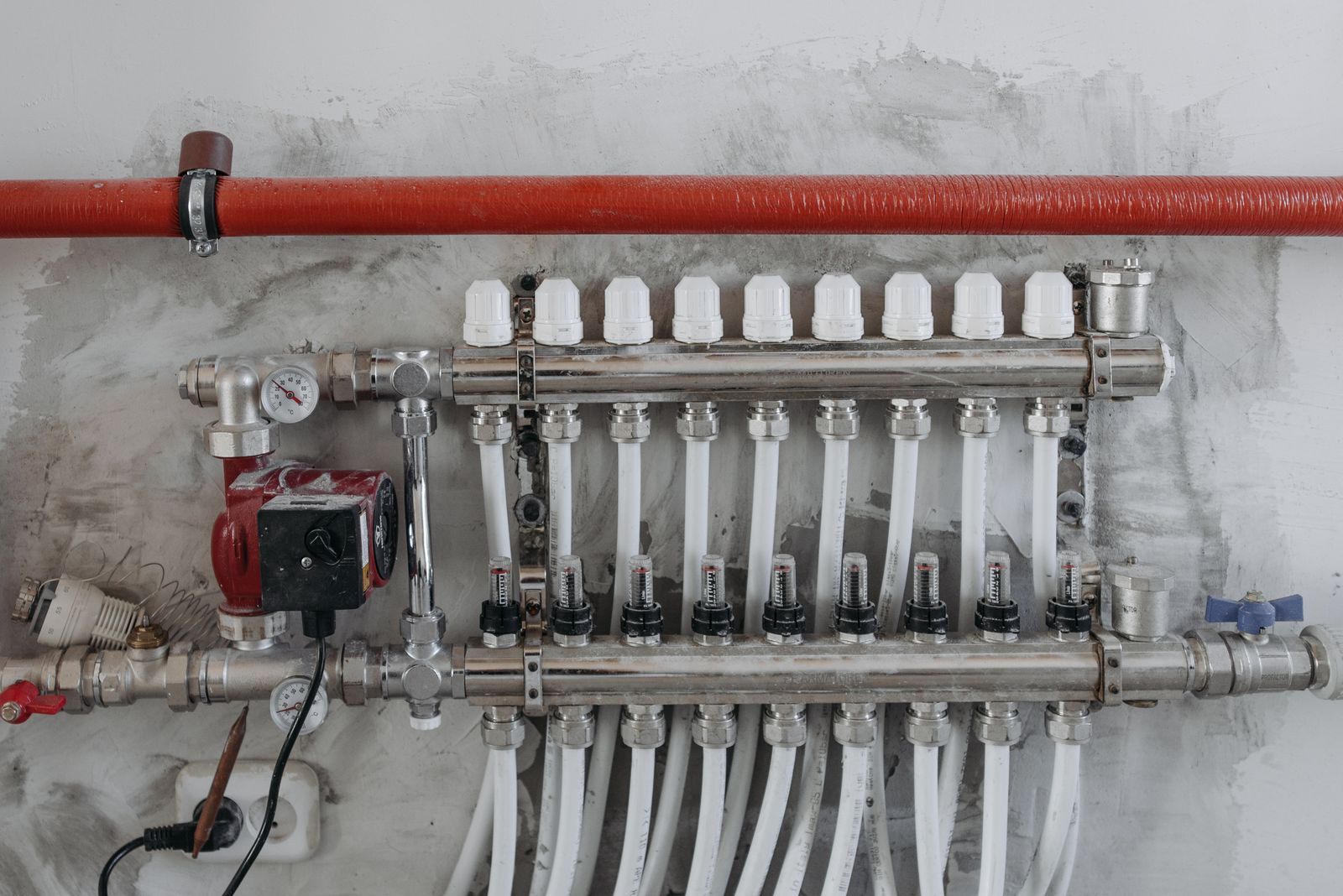 Neatly installed PEX manifold and gauges by Plumber On Dial